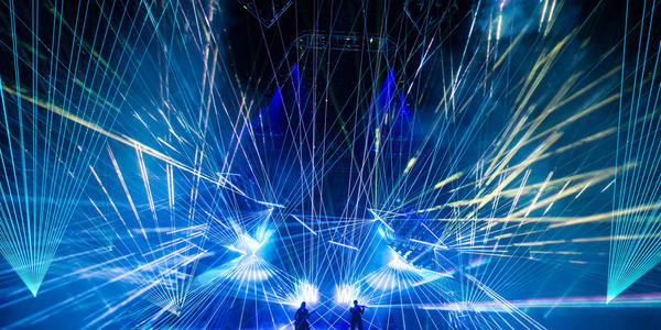 TSO perform electric rock opera with hundreds of blue strobe lights flashing in unison all across the stage
